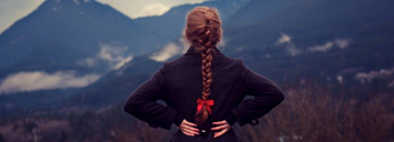 Student Standing ontop of a mountain, looking out